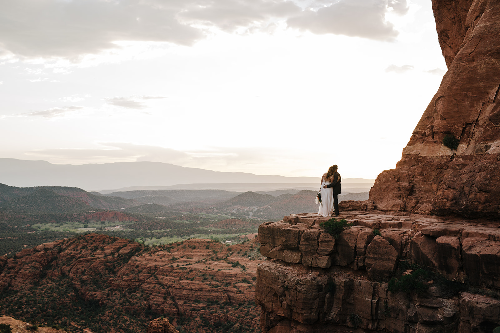 bride and groom look out over the Sedona desert after elopement