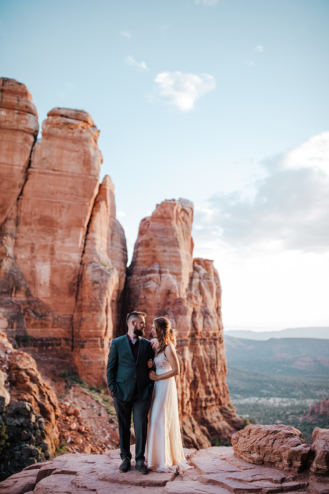 bride and groom on top of Sedona rock outcropping
