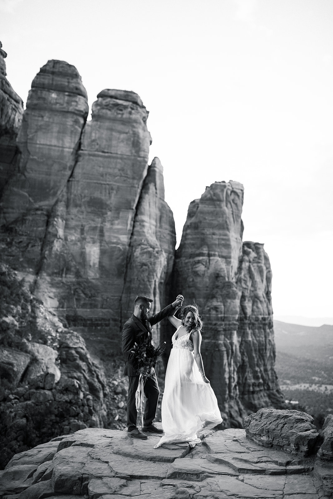 bride and groom on top of Sedona rock outcropping