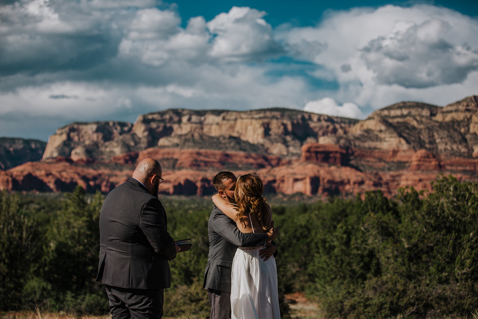 Bride and groom share first kiss in front of epic Sedona vista
