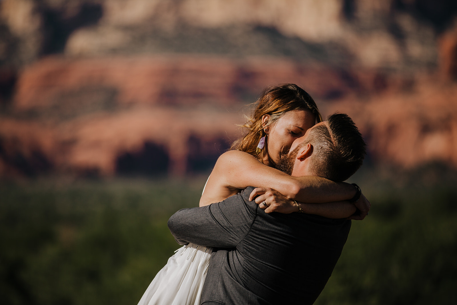 Bride and groom share first kiss in front of epic Sedona vista