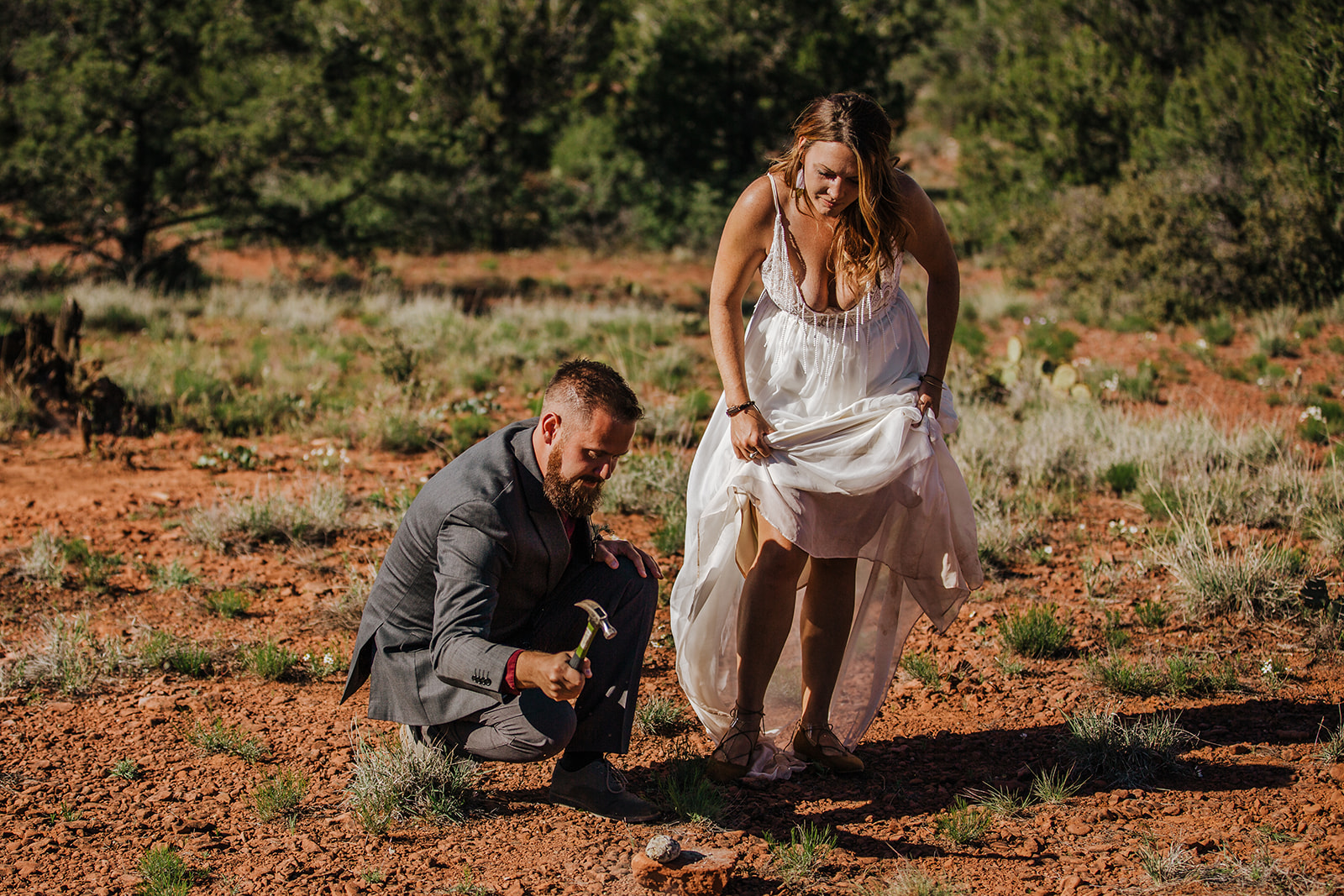 bride and groom perform ceremony to celebrate being married in desert elopement