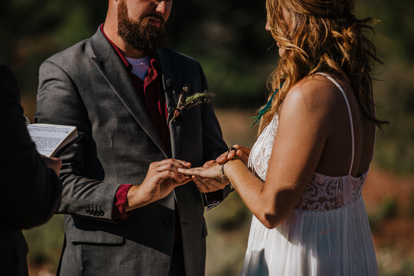 bride and groom exchange rings in elopement ceremony in Sedona Arizona