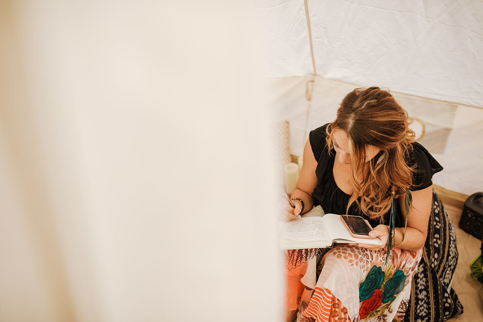 bride writing vows for elopement in desert tent