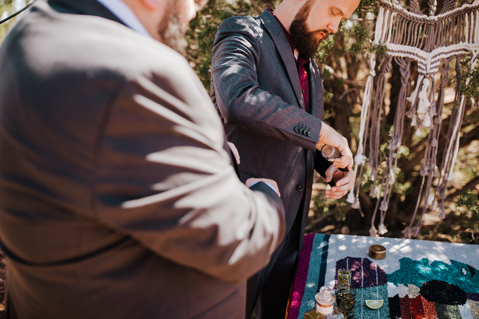 groom and officiant share a drink before elopement