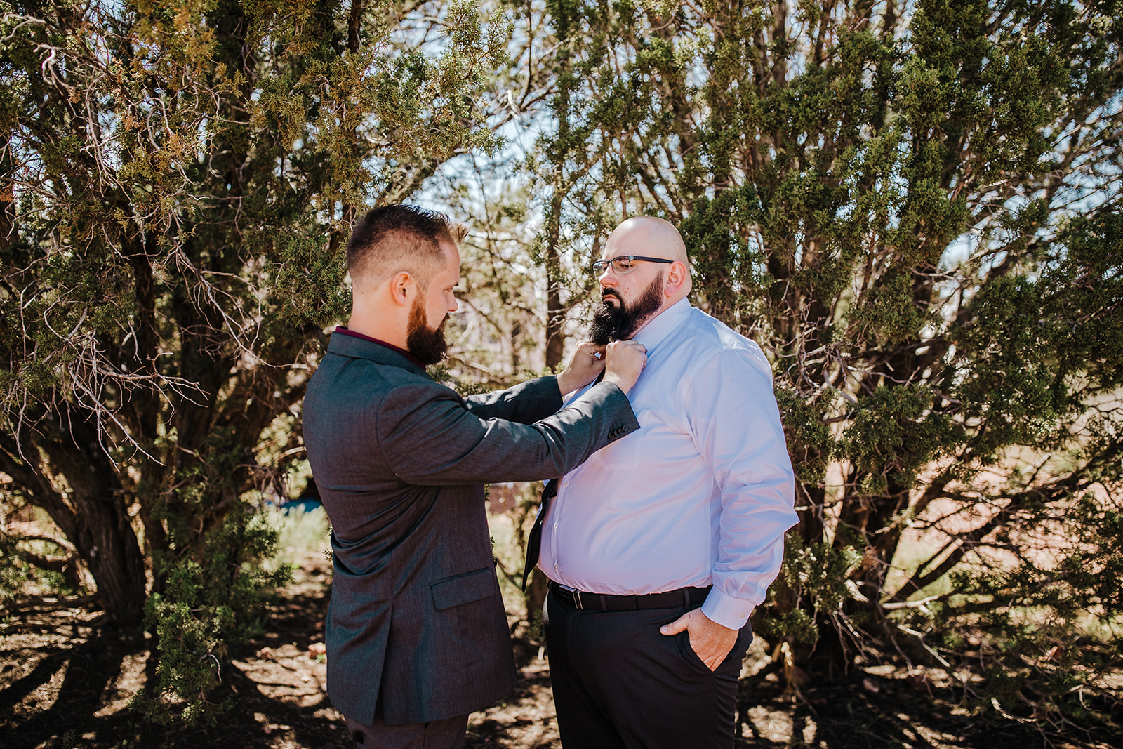 groom puts on jacket for Sedona Arizona elopement