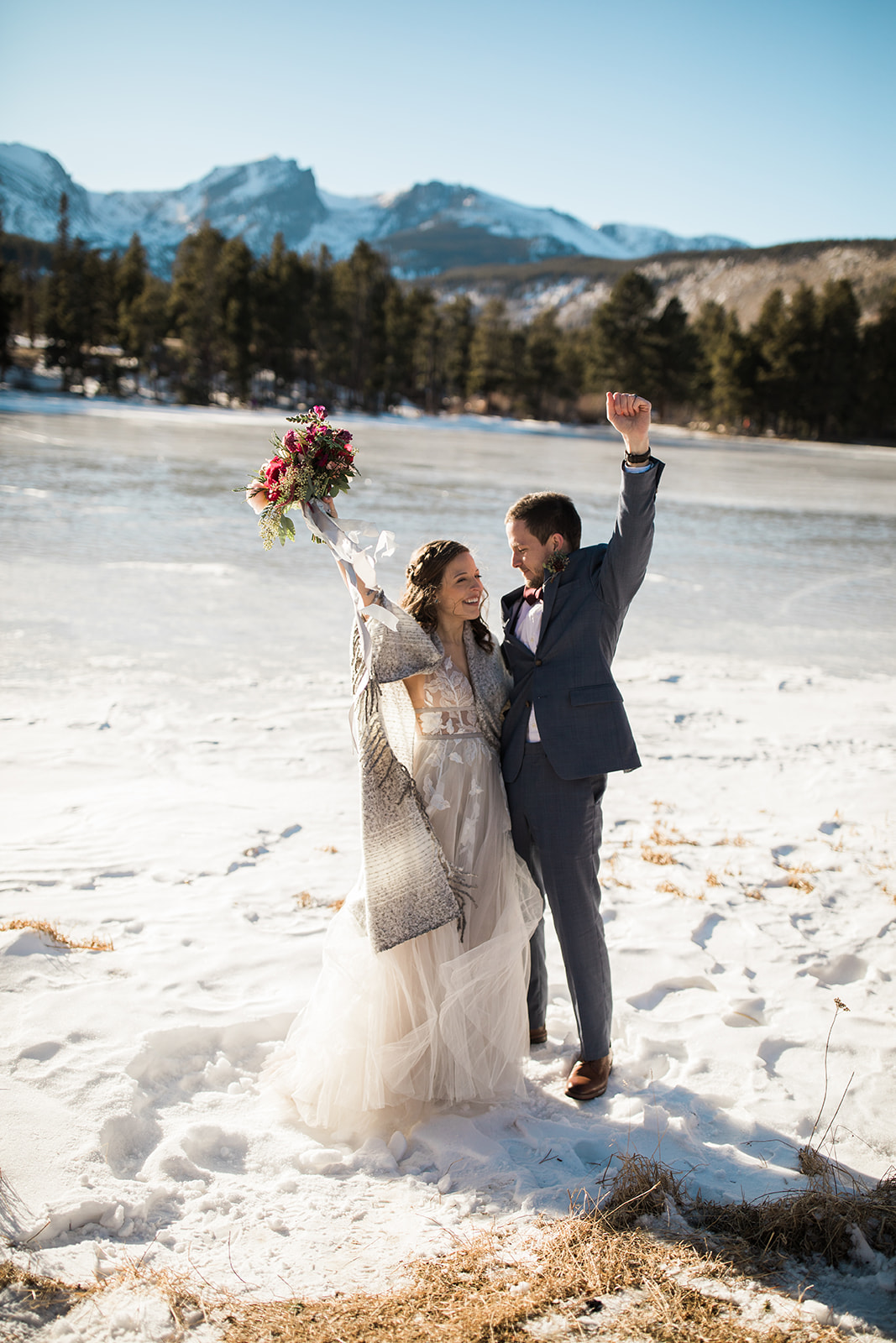 bride and groom first kiss after elopement at Sprague Lake Colorado