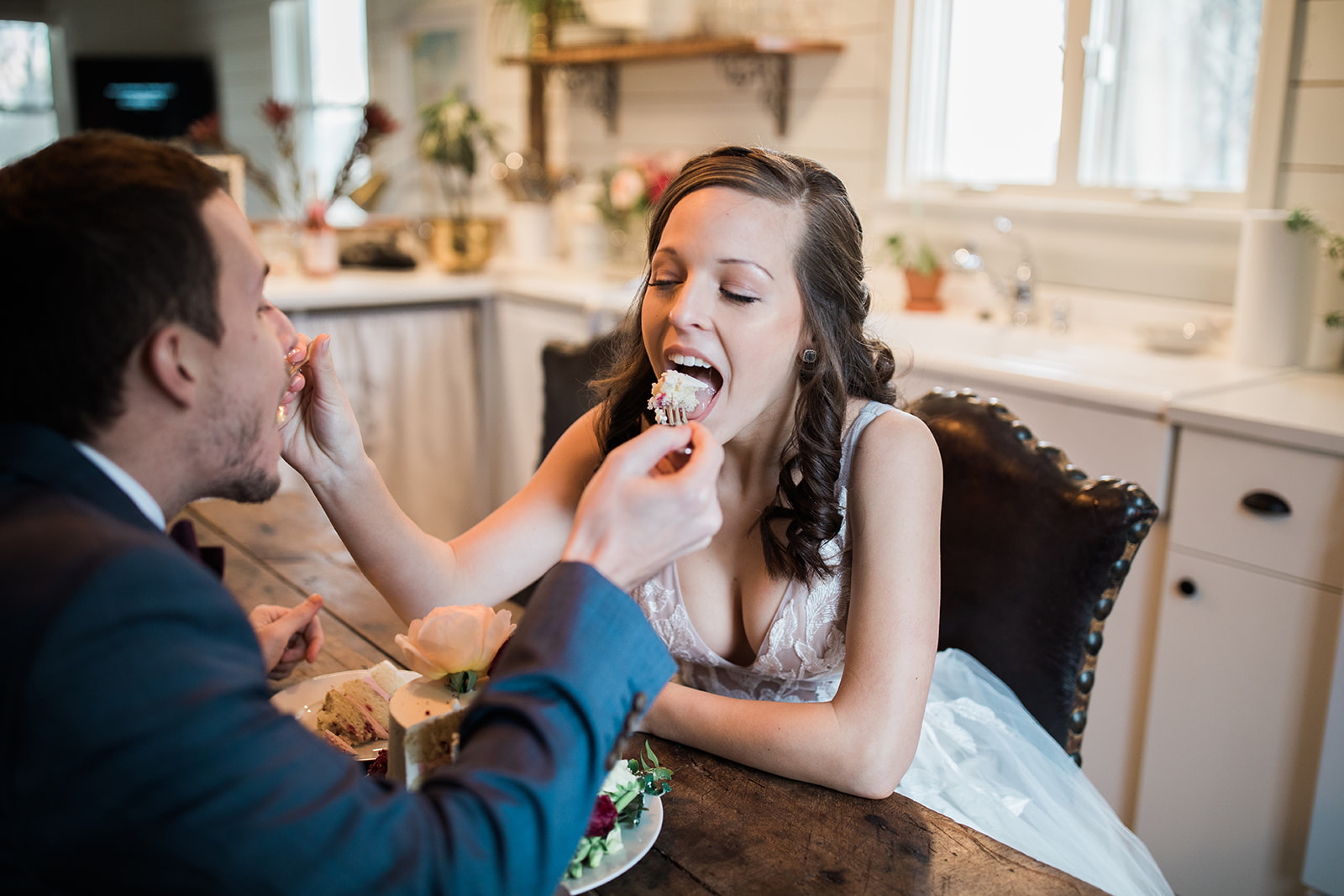 bride and groom cut wedding cake before elopement ceremony