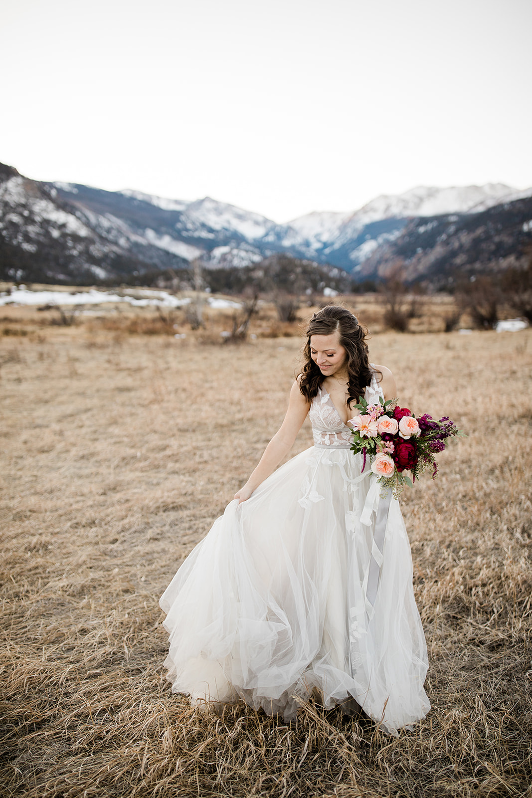 Colorado winter outdoor bride with dress and flowers in front of mountains