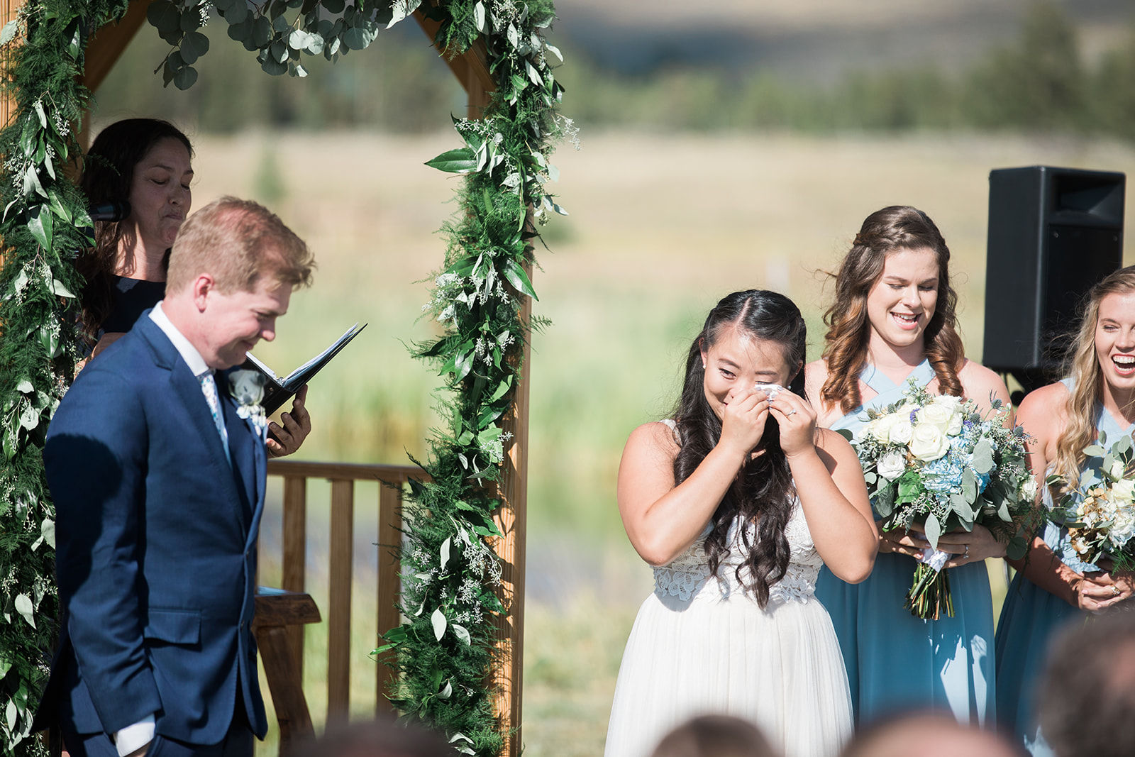 bride cries during outdoor mountain wedding ceremony