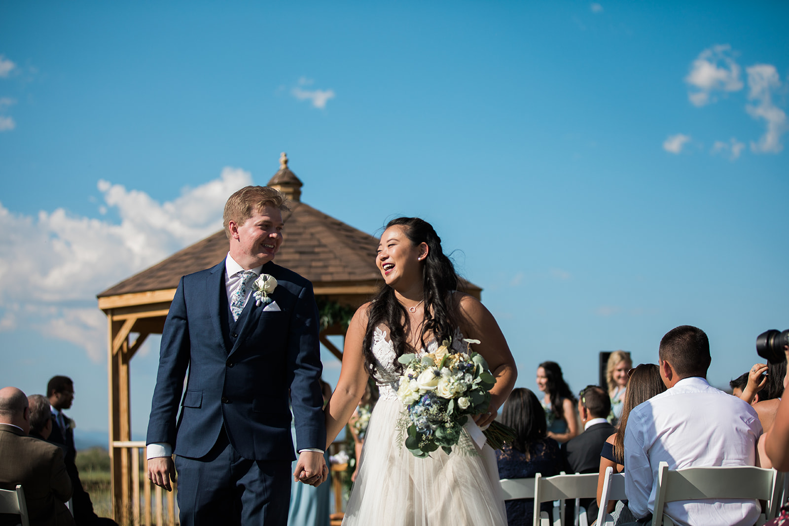 bride and groom walk down aisle after Lodge at Crestview Ranch wedding