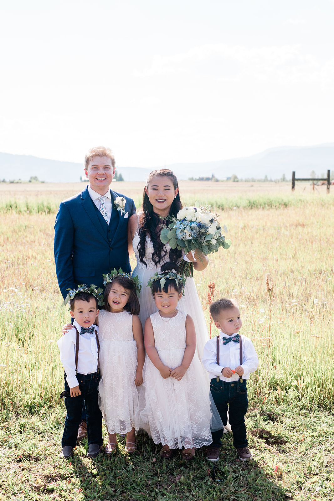 bride and groom pose with flower girls and ring bearers
