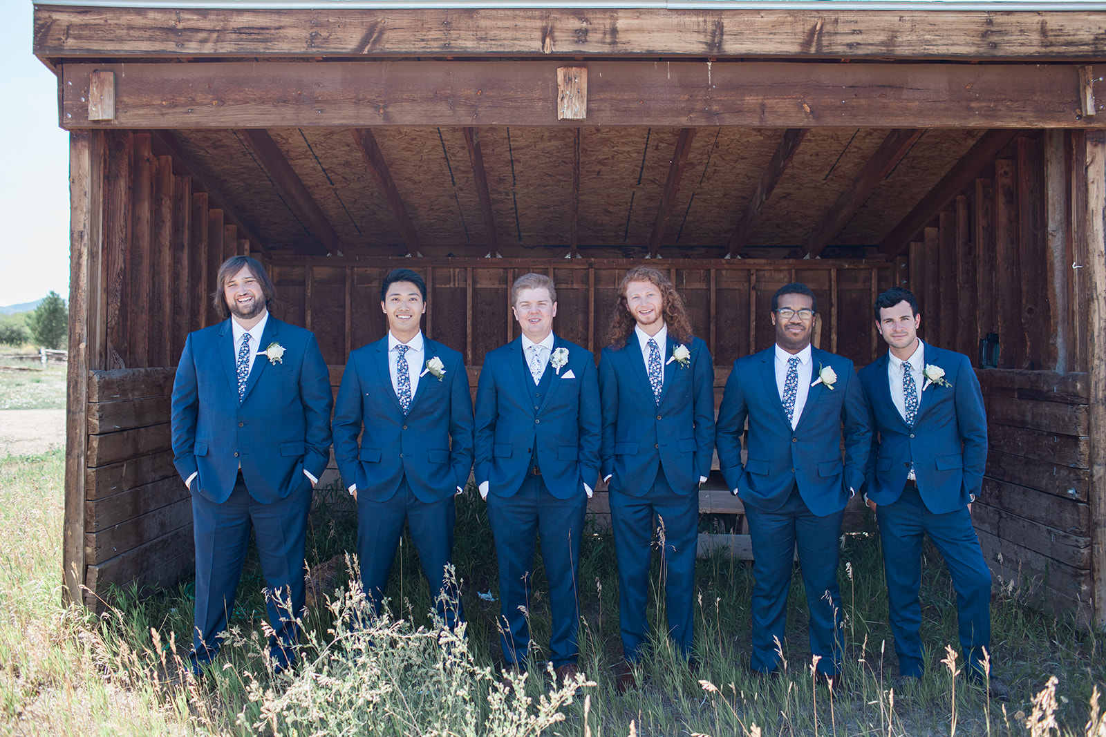 groomsmen posing outside Crestview Ranch building