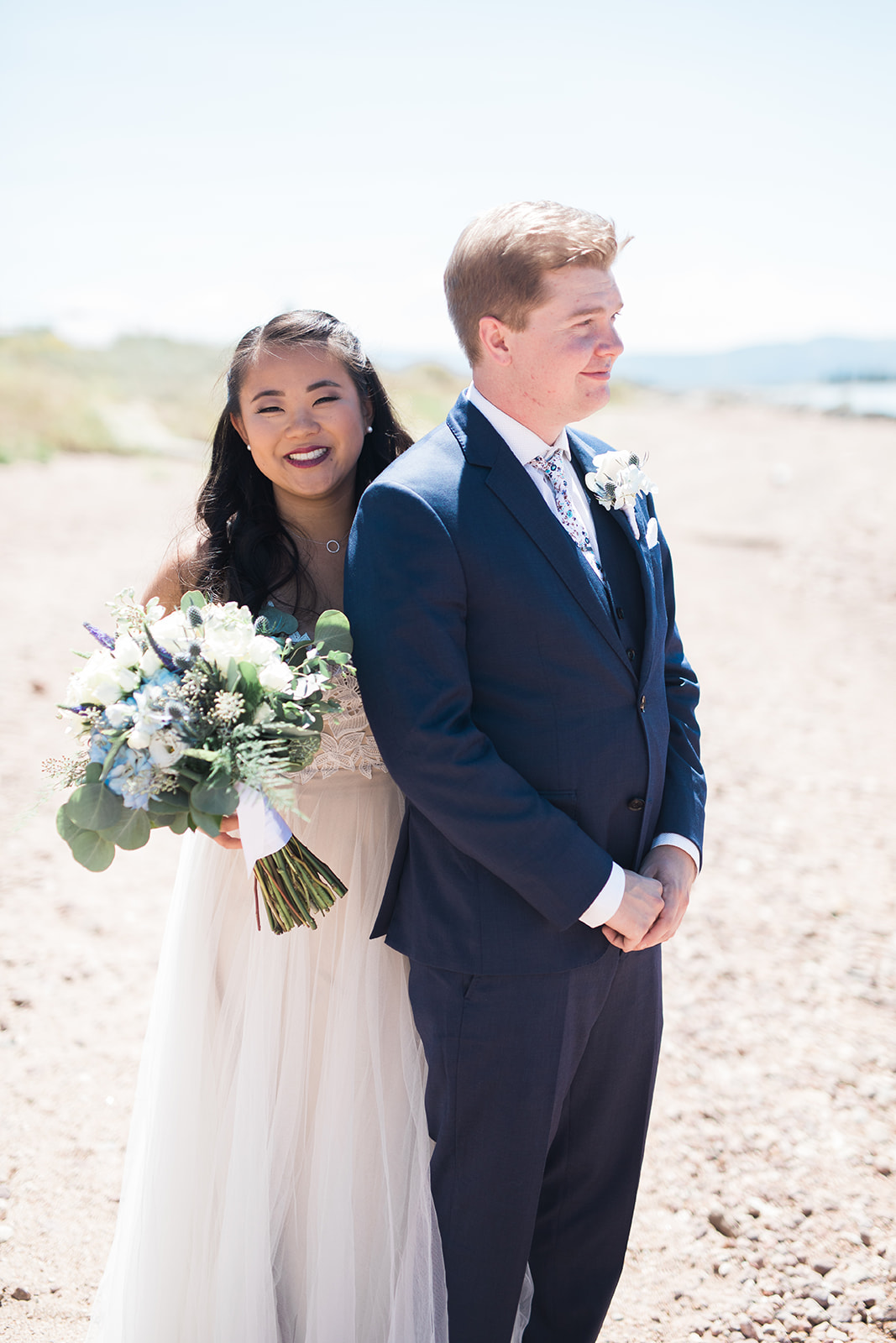 bride walks up behind groom for first look at Crestview Ranch in Colorado