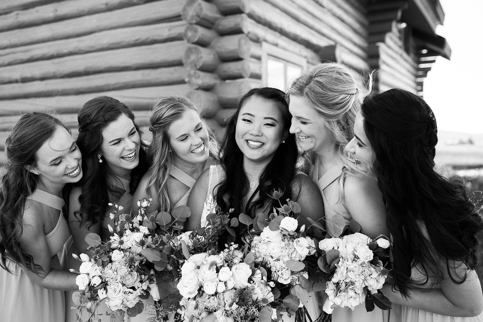bride and bridesmaids posing outside Crestview Ranch building
