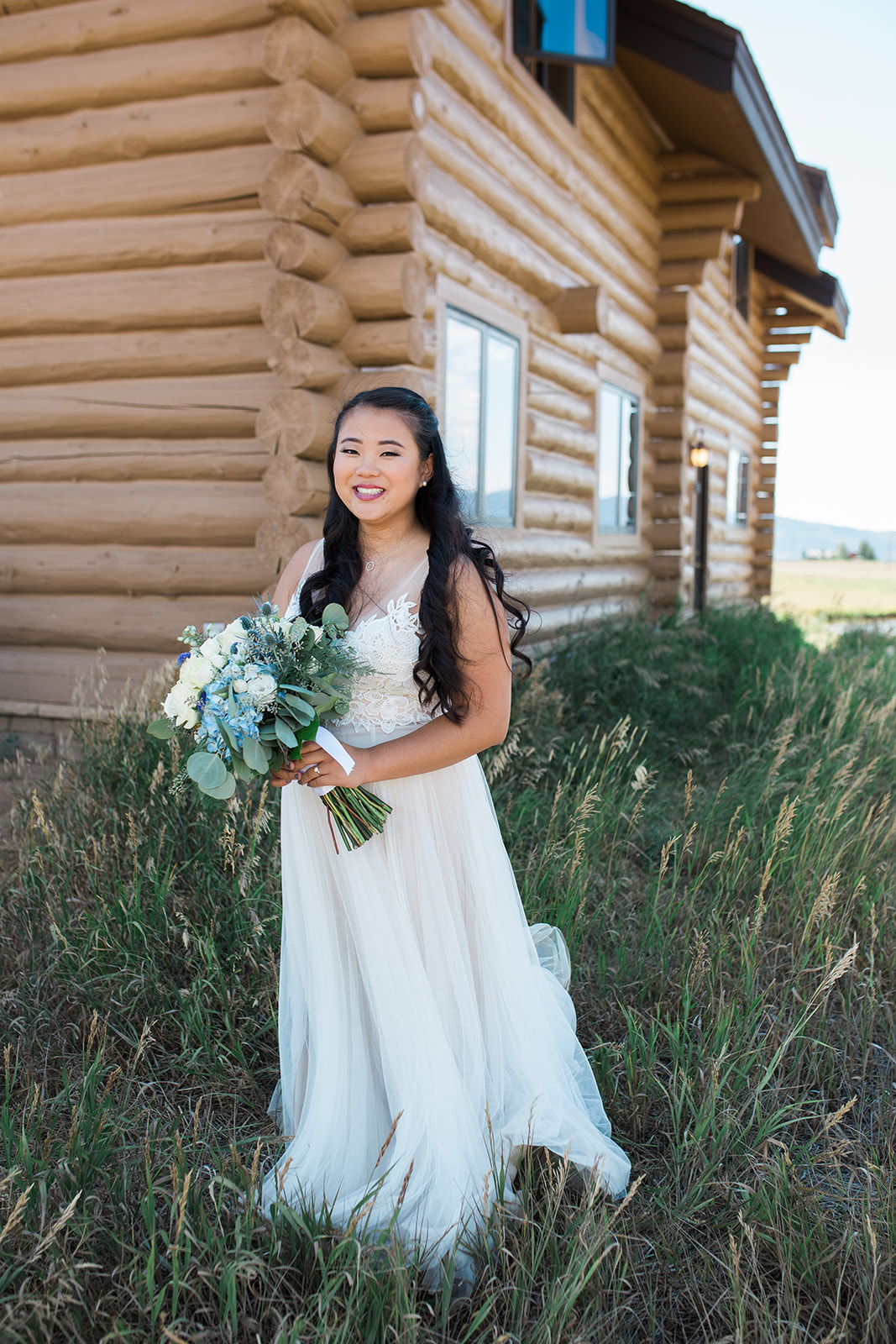 bride posing outside Crestview Ranch building