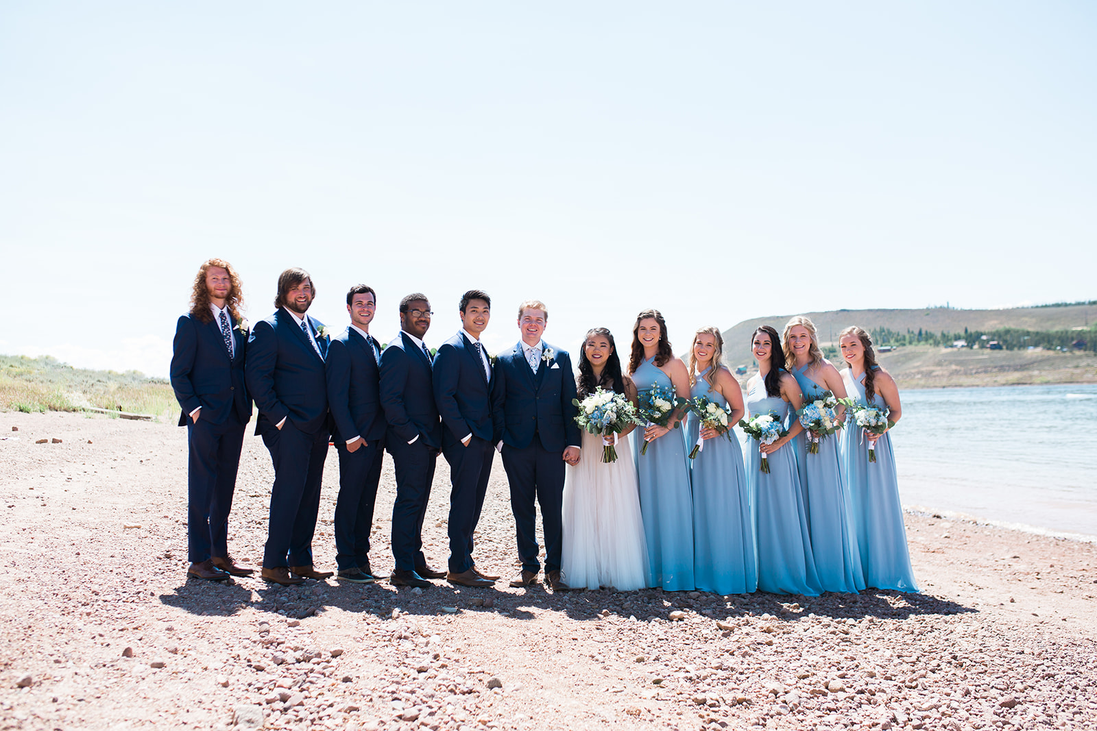 bridal party posing near a Colorado mountain lake