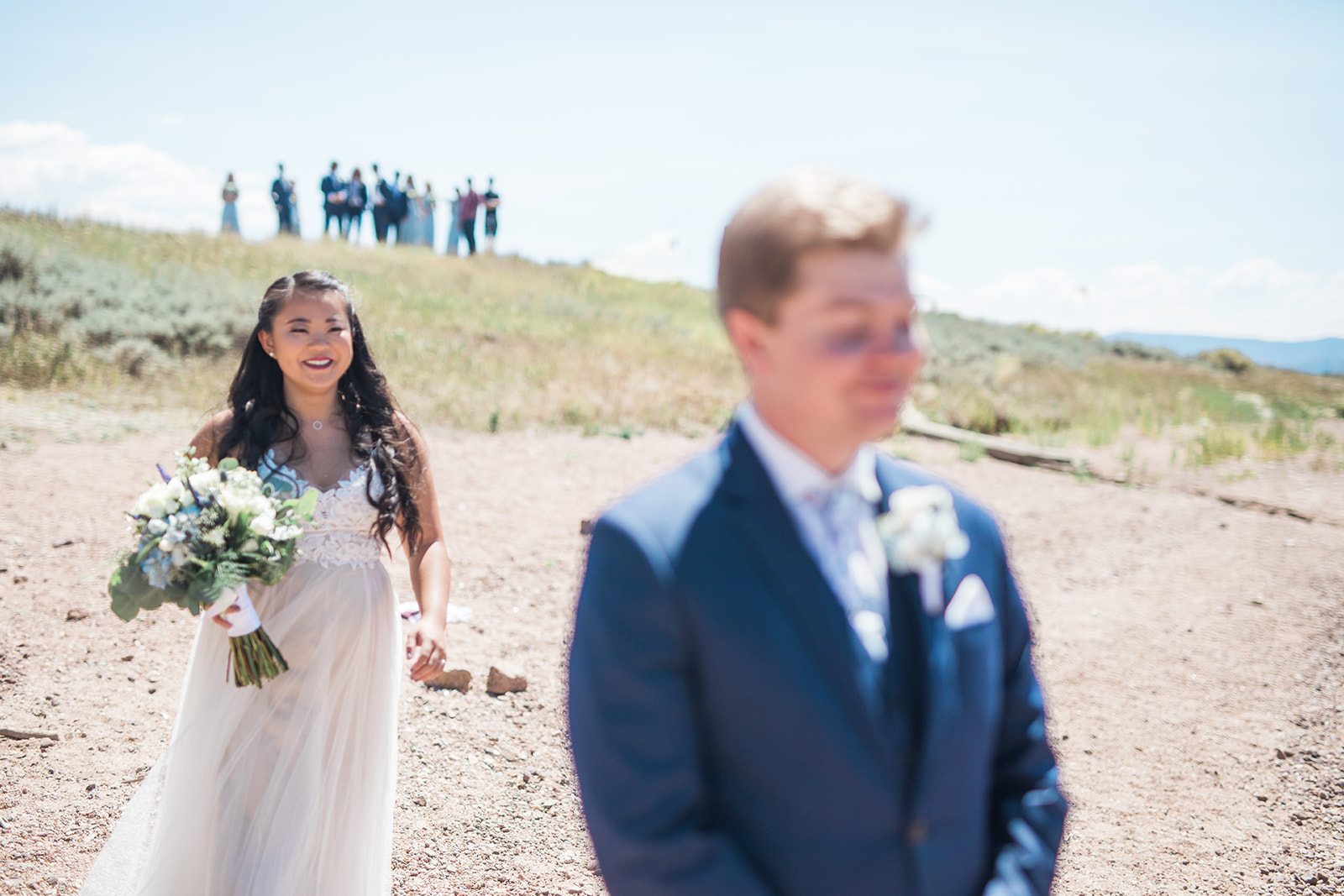 bride walks up behind groom for first look at Crestview Ranch in Colorado