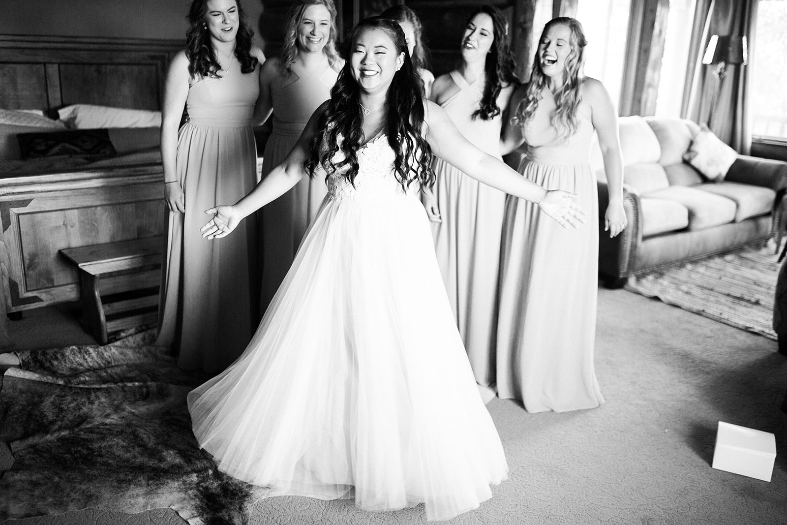 bridesmaids see bride in her dress for the first time