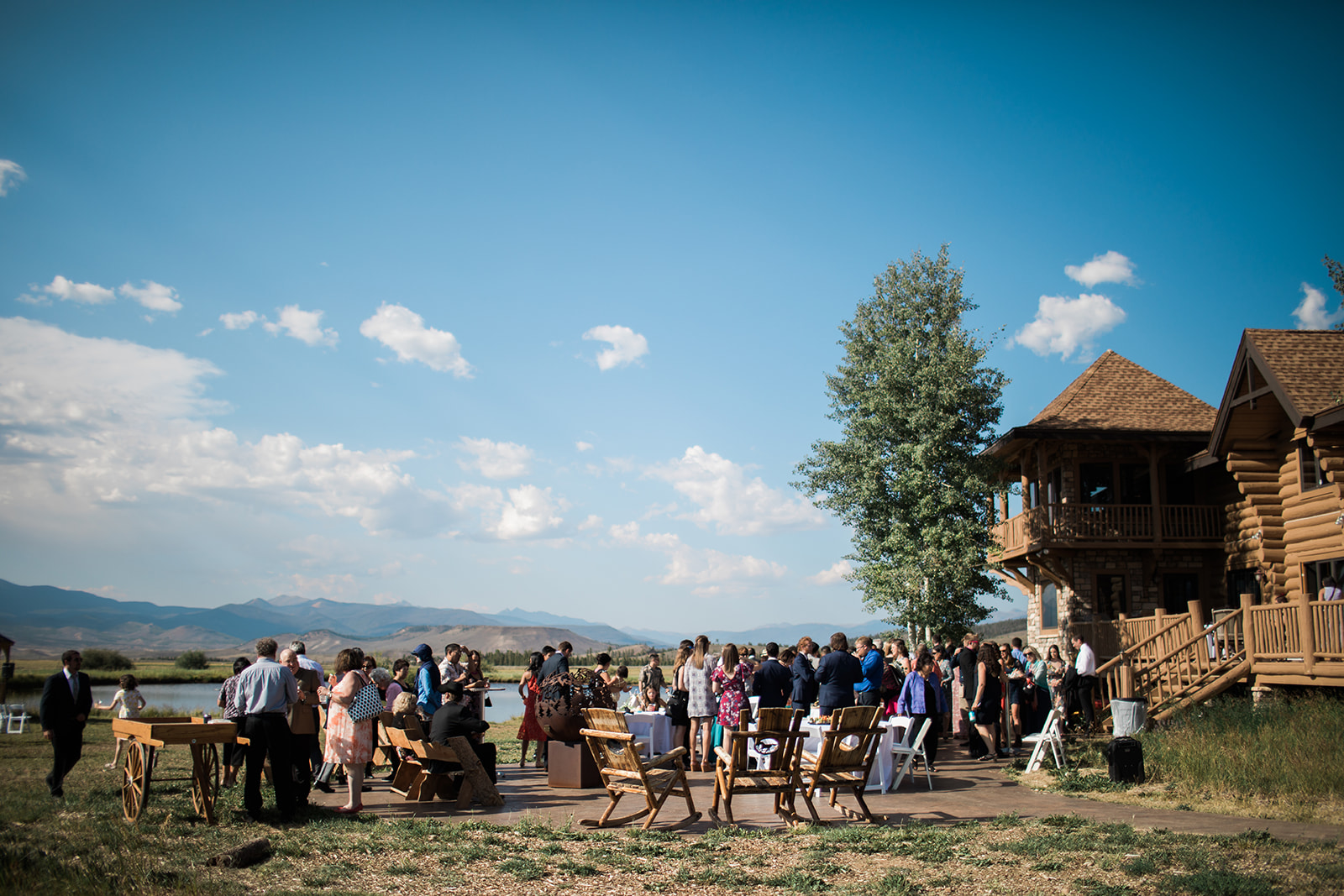guests enjoying cocktail hour outside the lodge at Crestview Ranch