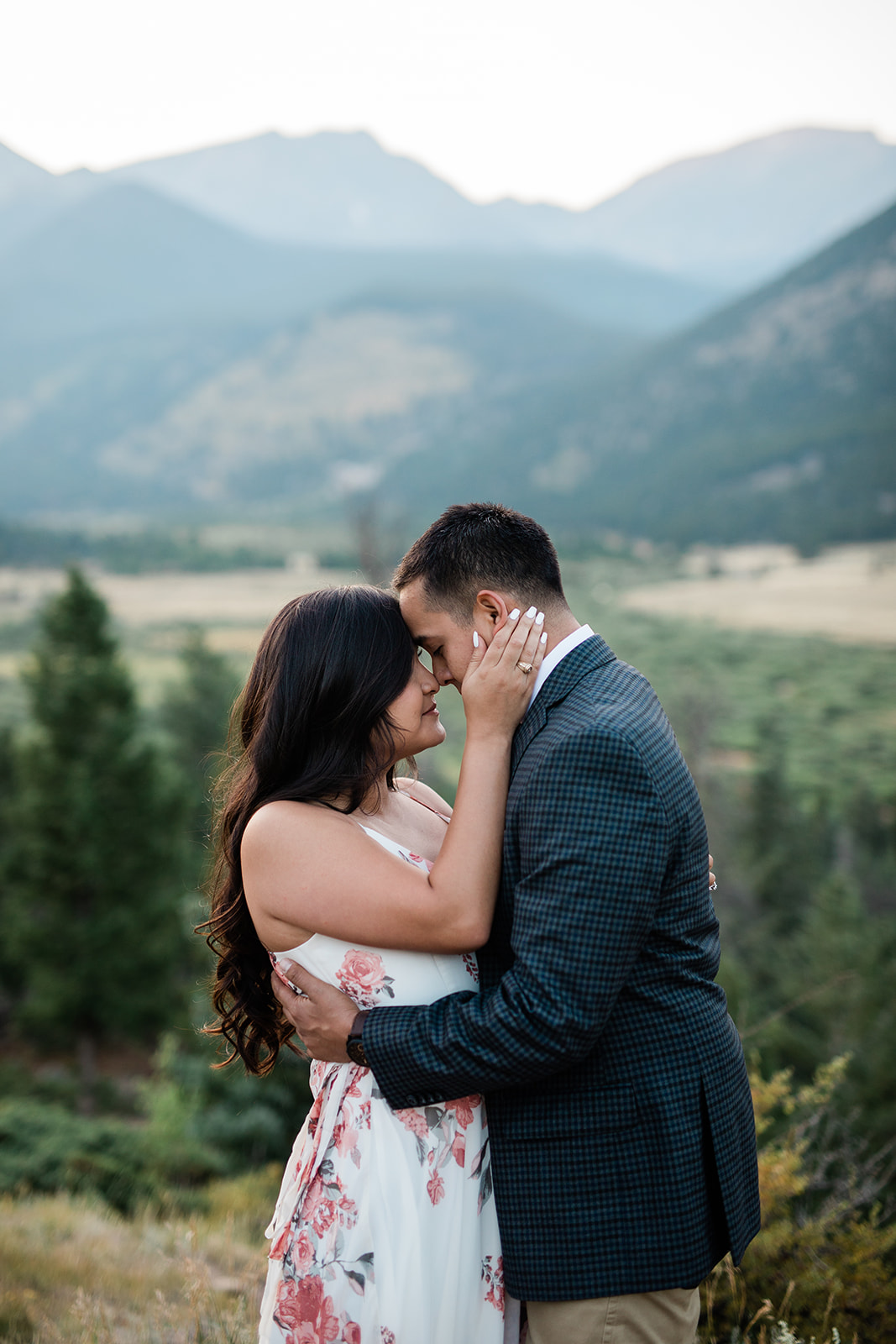 engaged couple in front of Rocky Mountain vista