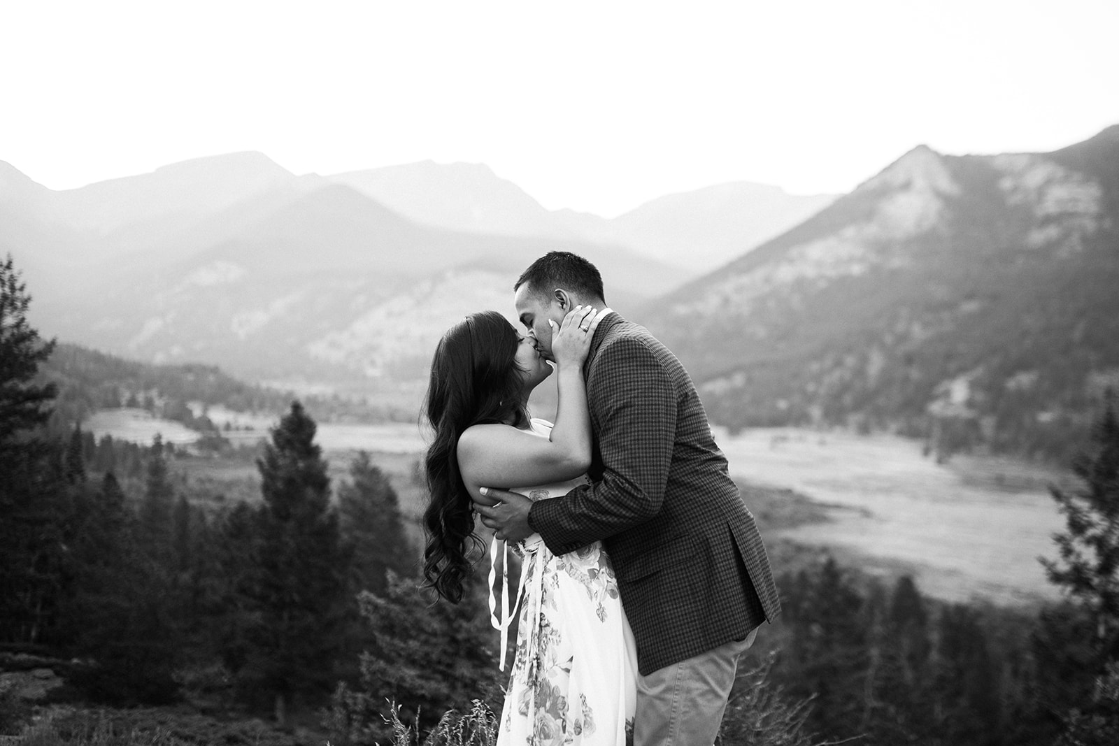 engaged couple in front of Rocky Mountain vista