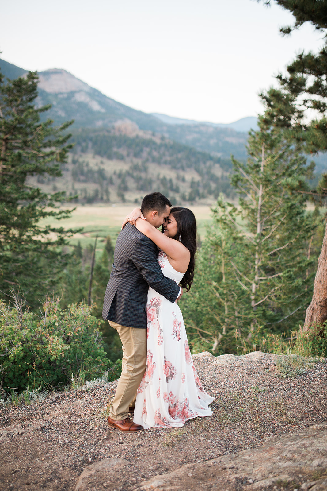 engaged couple in front of Colorado mountain view