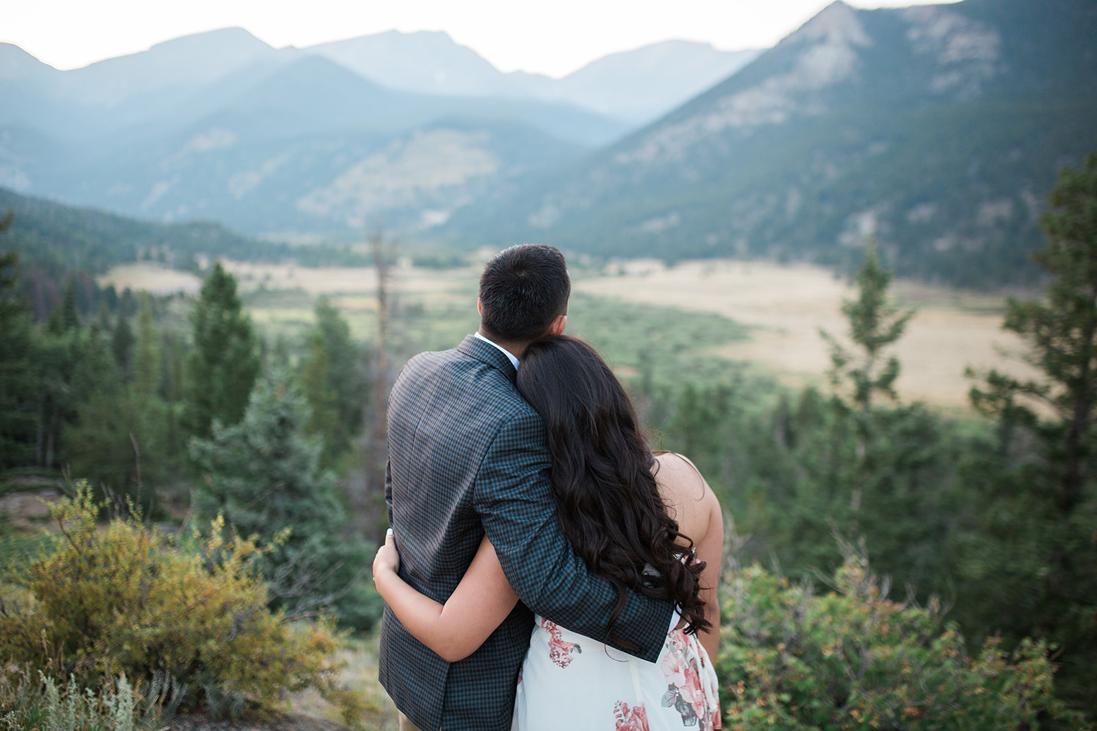 engaged couple in front of Colorado mountain view