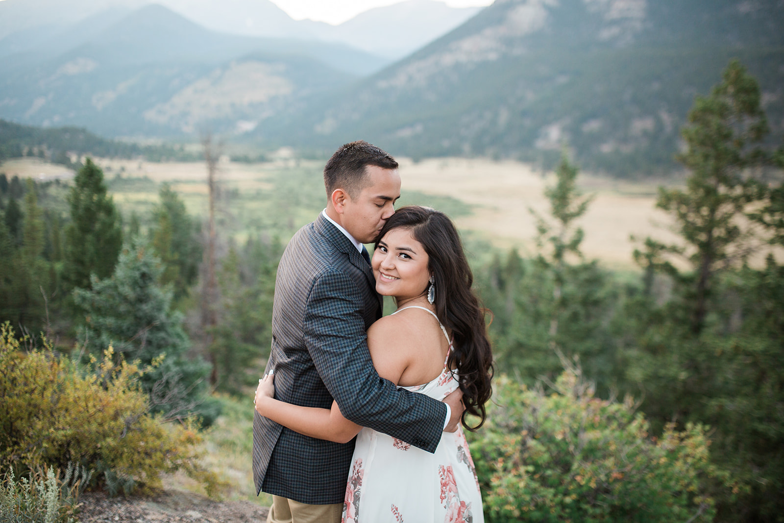 engaged couple in front of Colorado mountain view