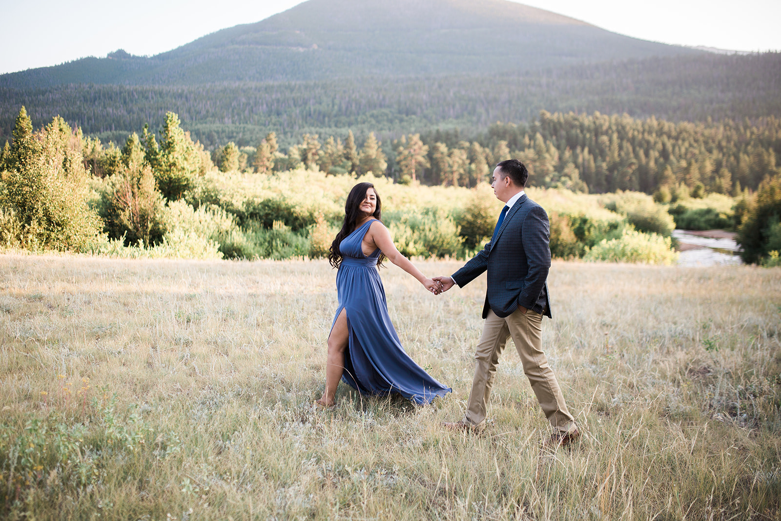 couple walking across Rocky Mountain National Park grassland