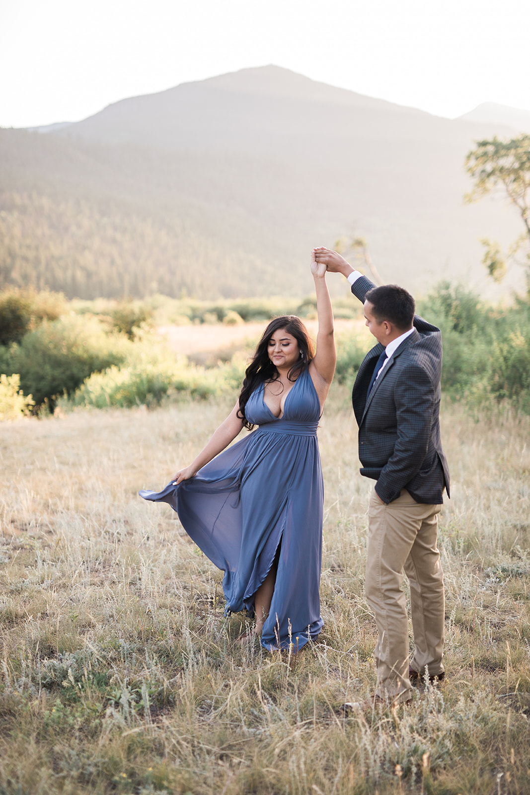 engaged couple dancing in a RMNP meadow