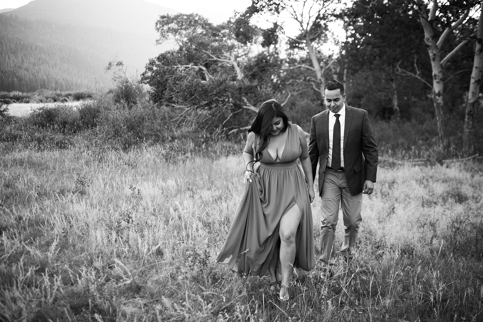 couple walks across RMNP meadow