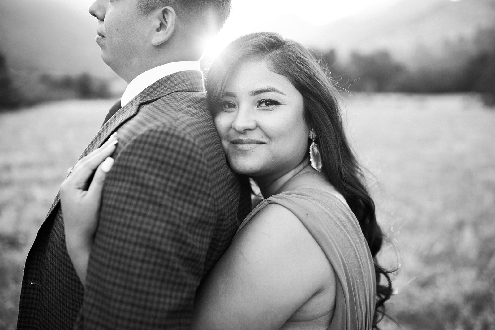woman hugs man during Colorado mountain sunset