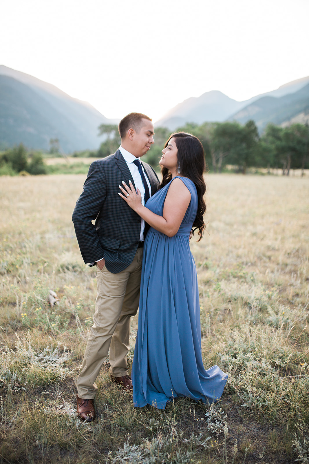 woman hugs man during Colorado mountain sunset