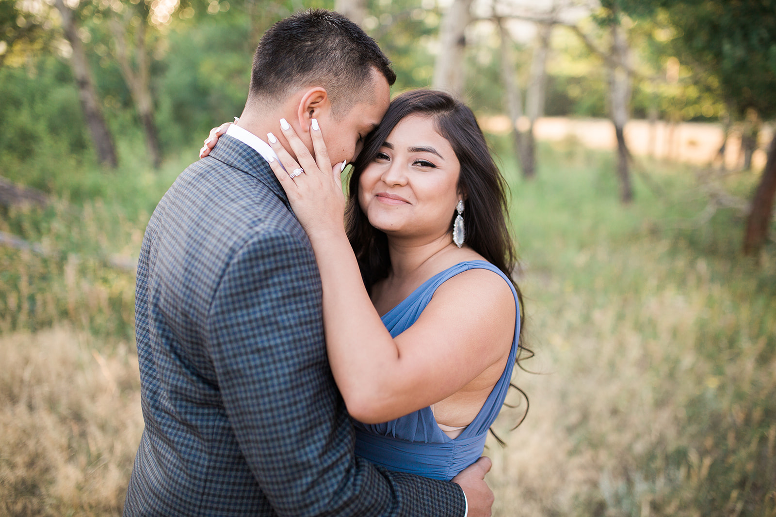 close up engaged couple, plaid jacket blue dress