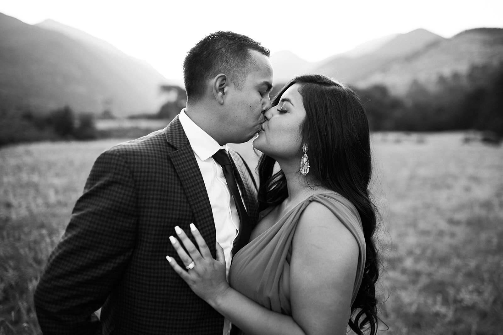 engaged couple kisses during Colorado mountain sunset engagement session