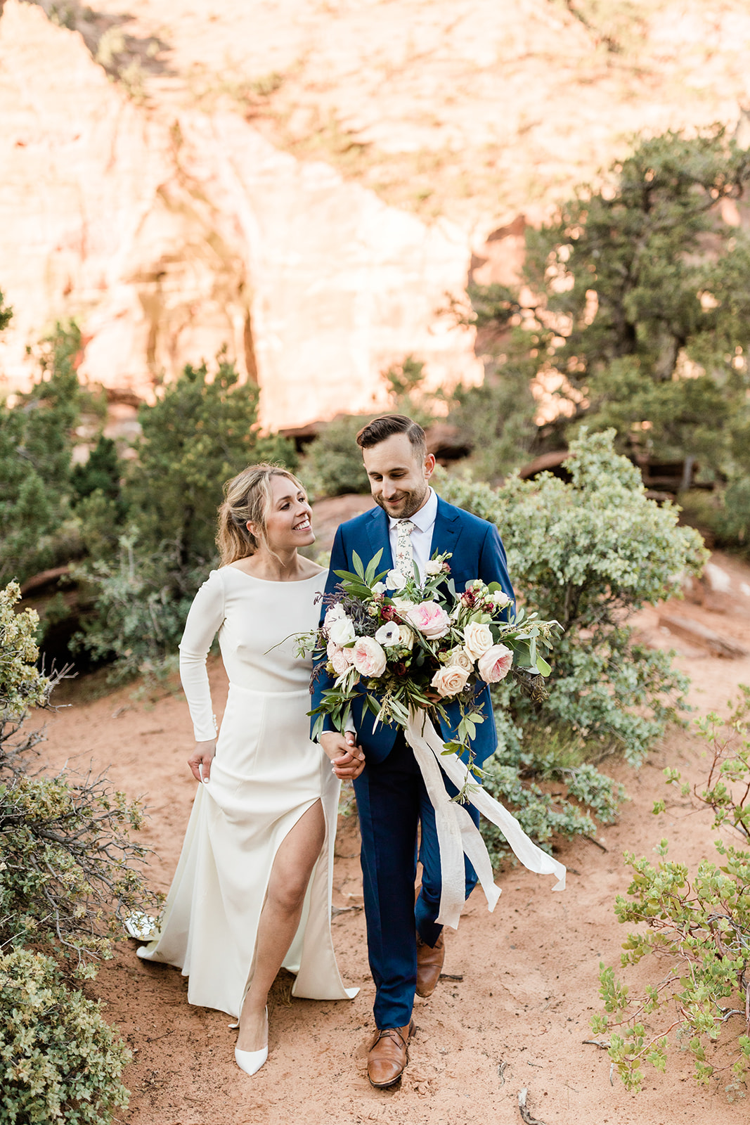 bride and groom walk to their elopement ceremony in Zion National Park