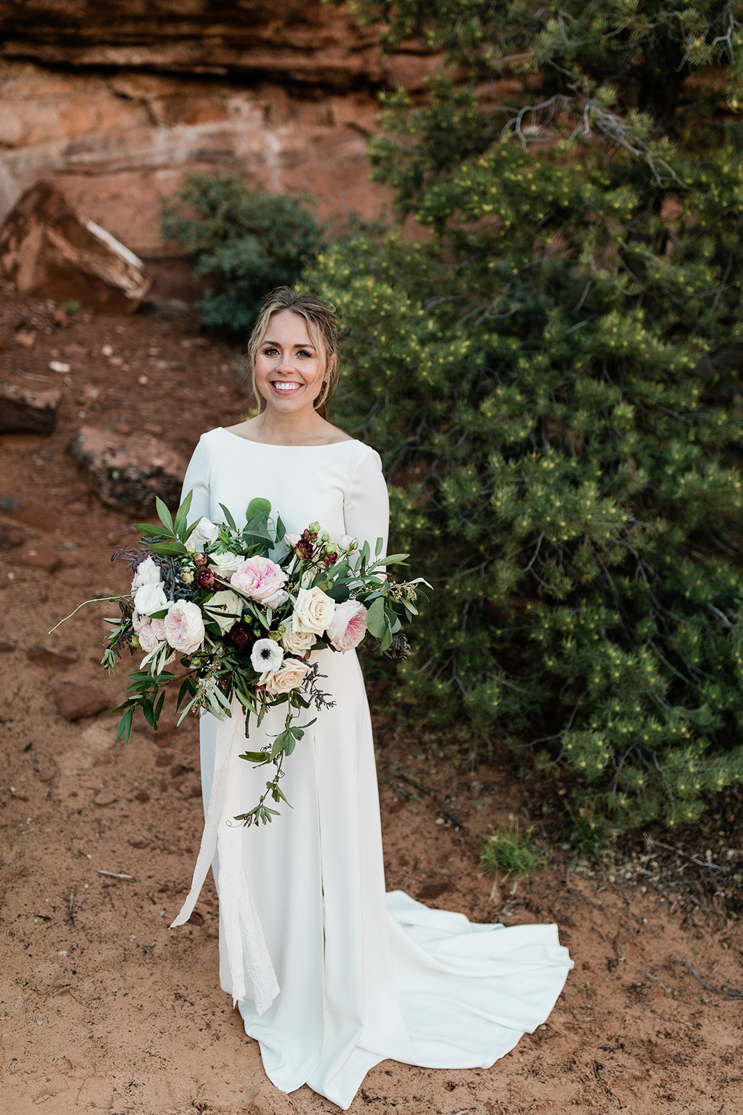 bride poses with bouquet before elopement