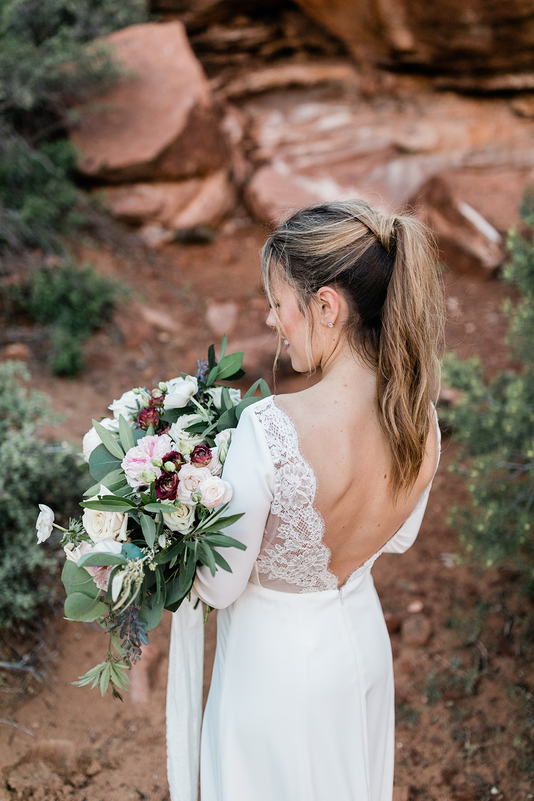 bride poses with bouquet before elopement