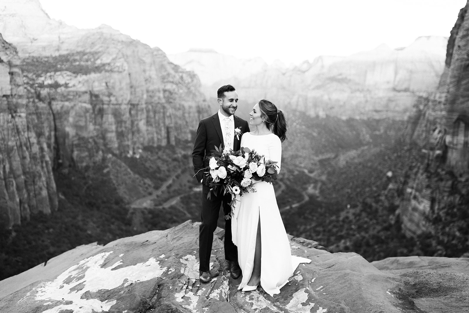 bride and groom see each other for first time before elopement in front of stunning desert vista