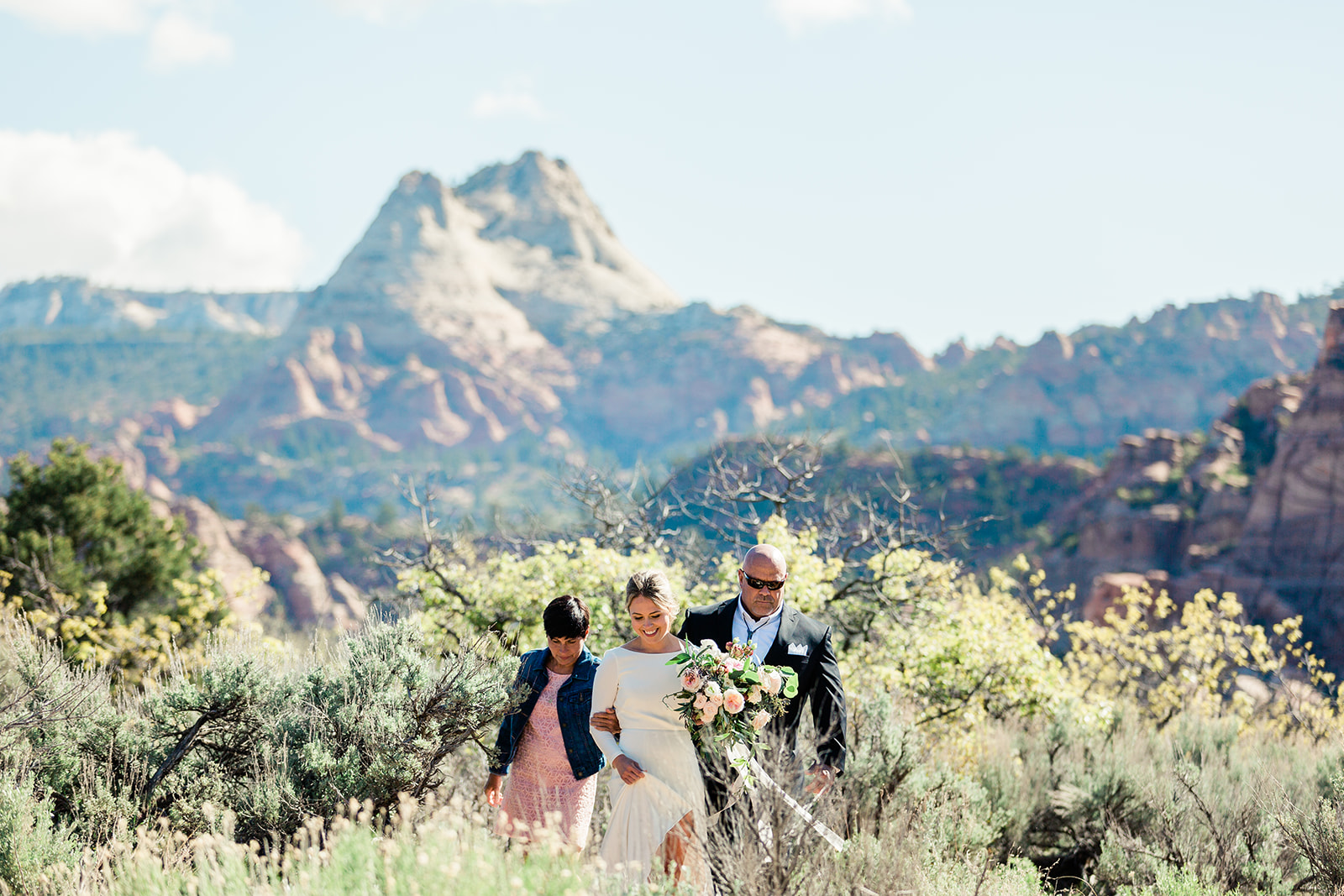 bride and attendants approach gorgeous Zion elopement spot