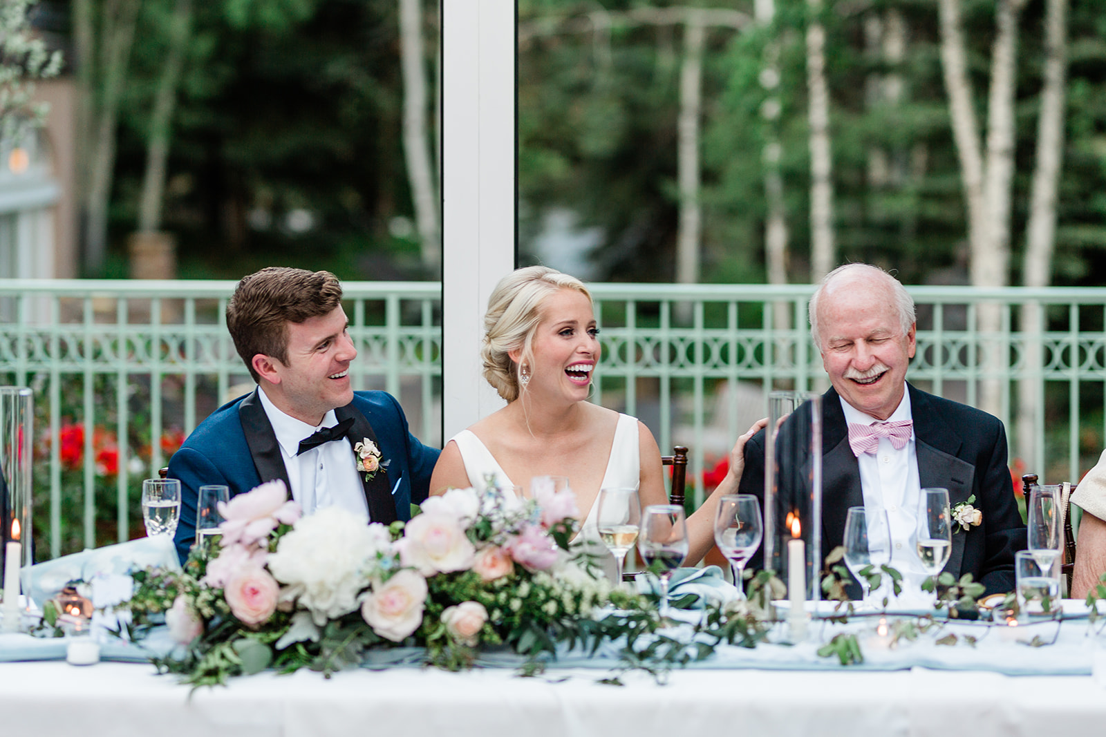 bride and groom laugh during toasts