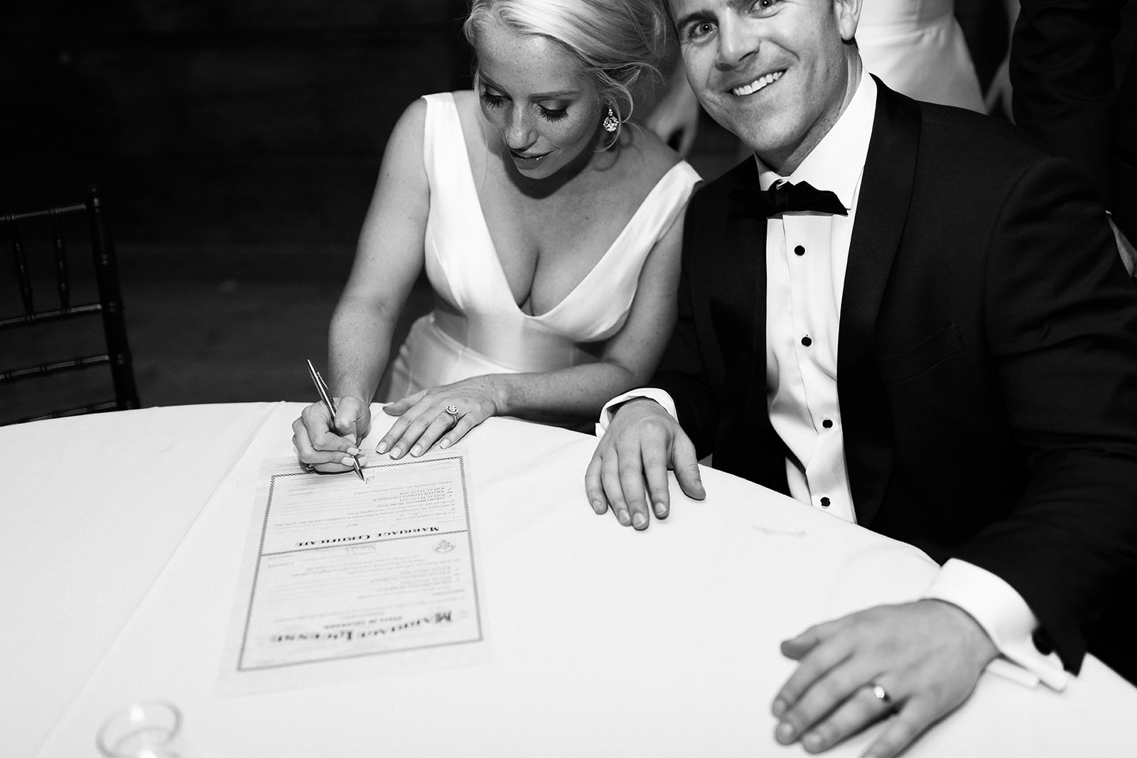 bride and groom sign marriage certificate