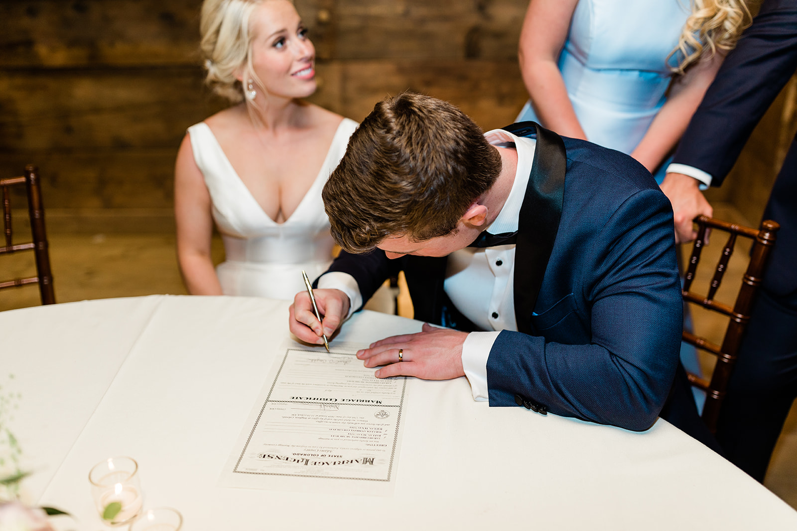 bride and groom sign marriage certificate