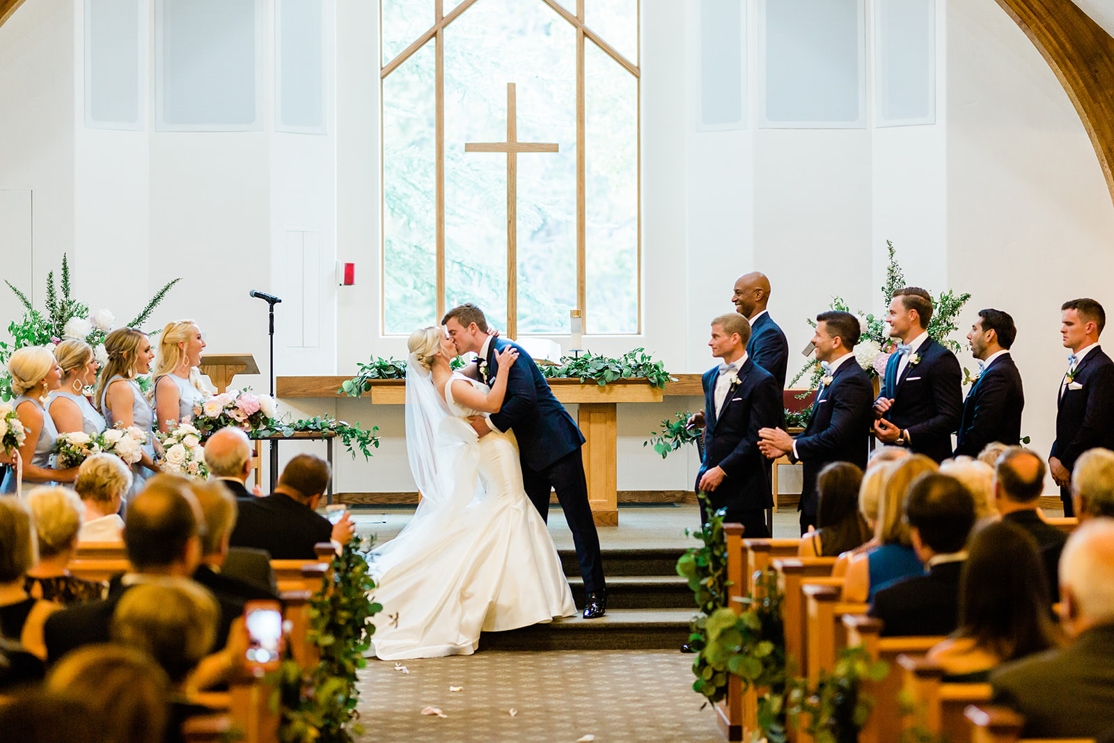 bride and groom first kiss in Vail chapel