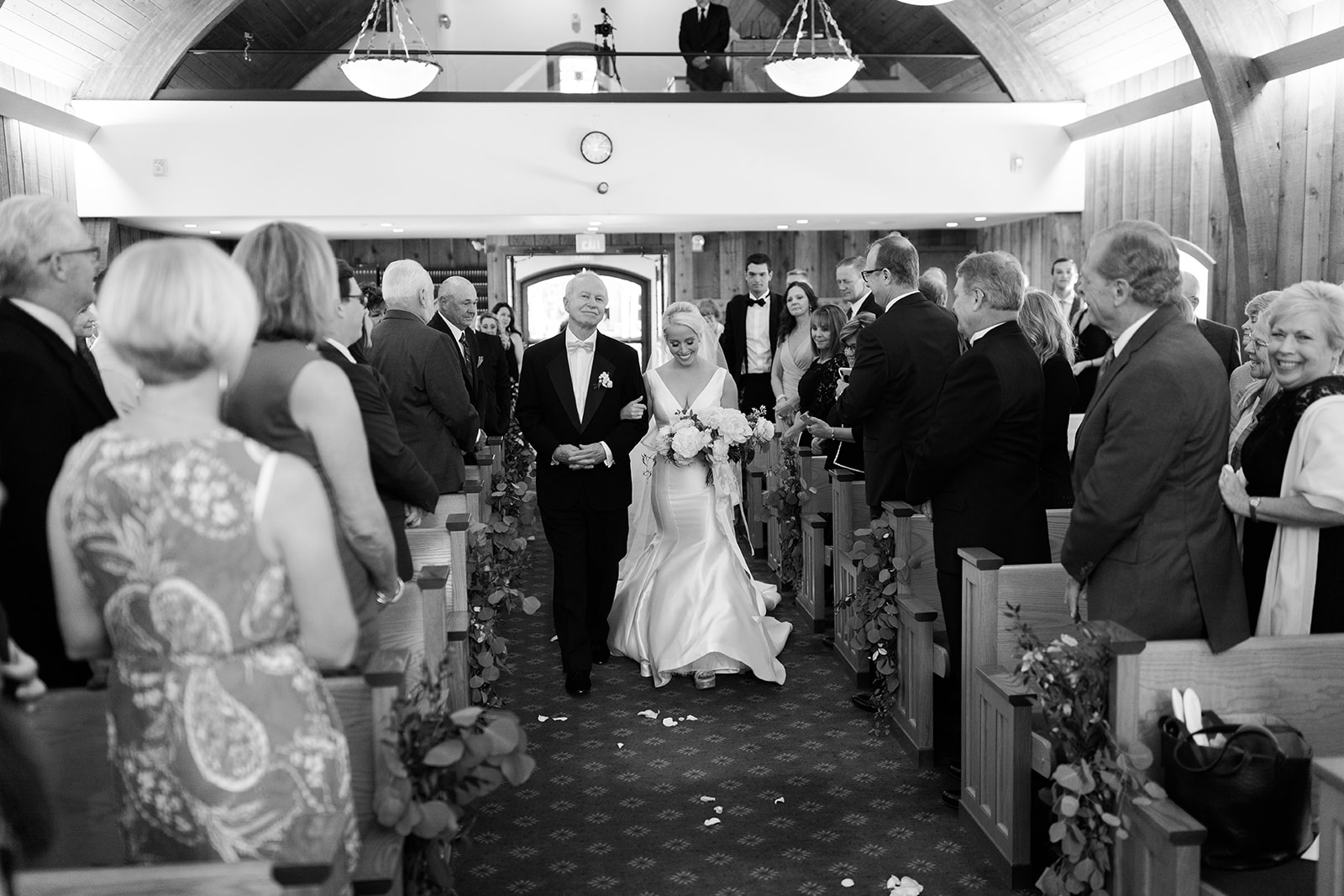 bride walks down aisle of Vail wedding chapel