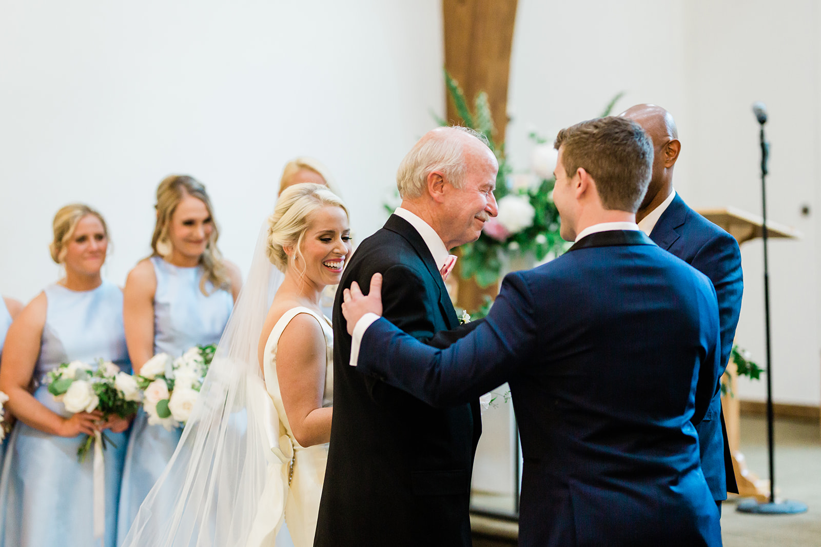father hands bride to groom at alter
