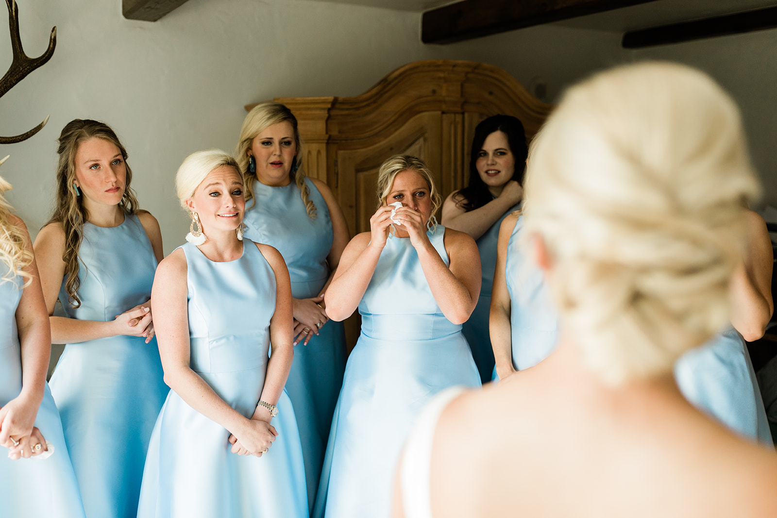 bridesmaids help bride get dressed in wedding dress the morning of her Vail wedding