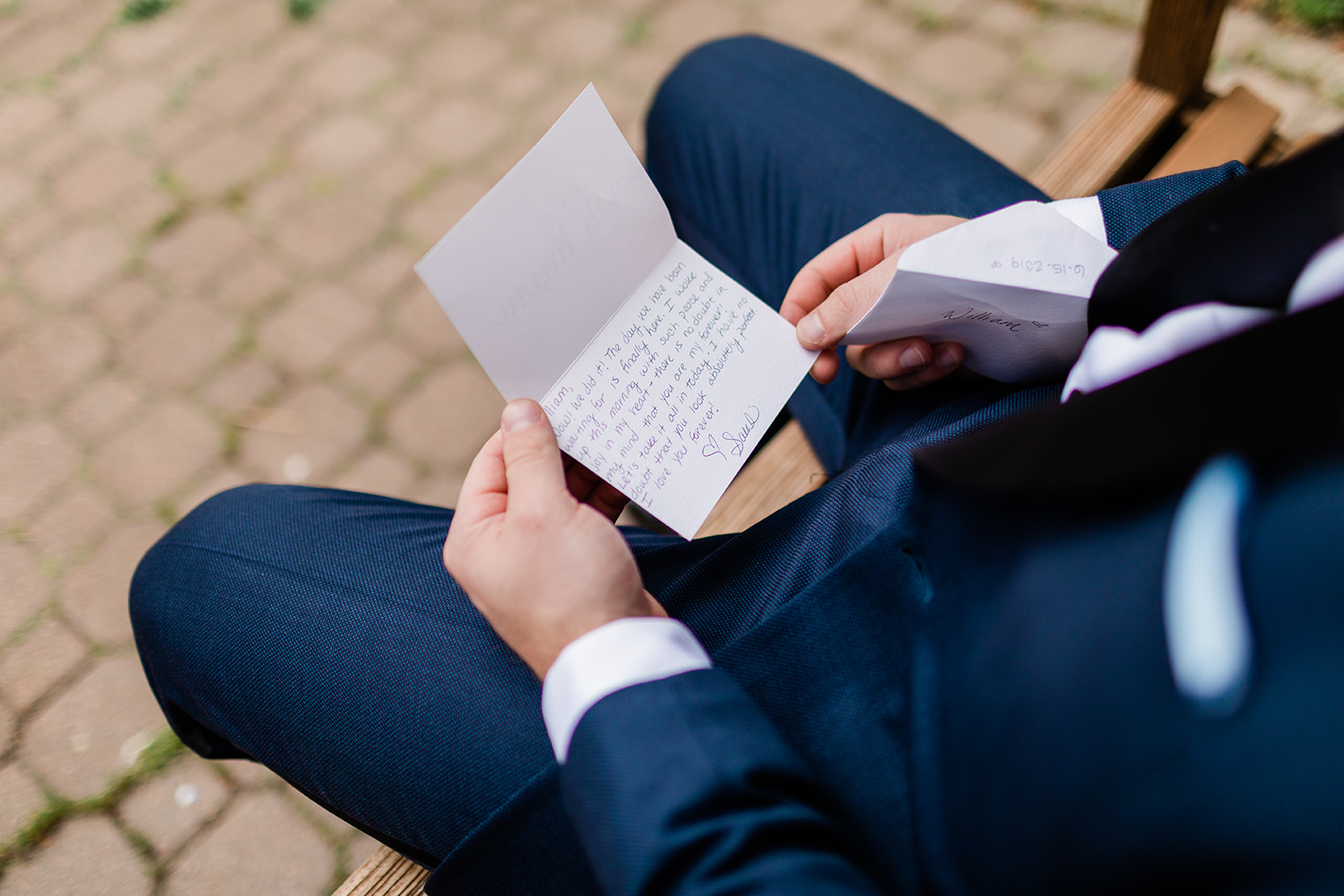 groom reading note from bride before wedding ceremony