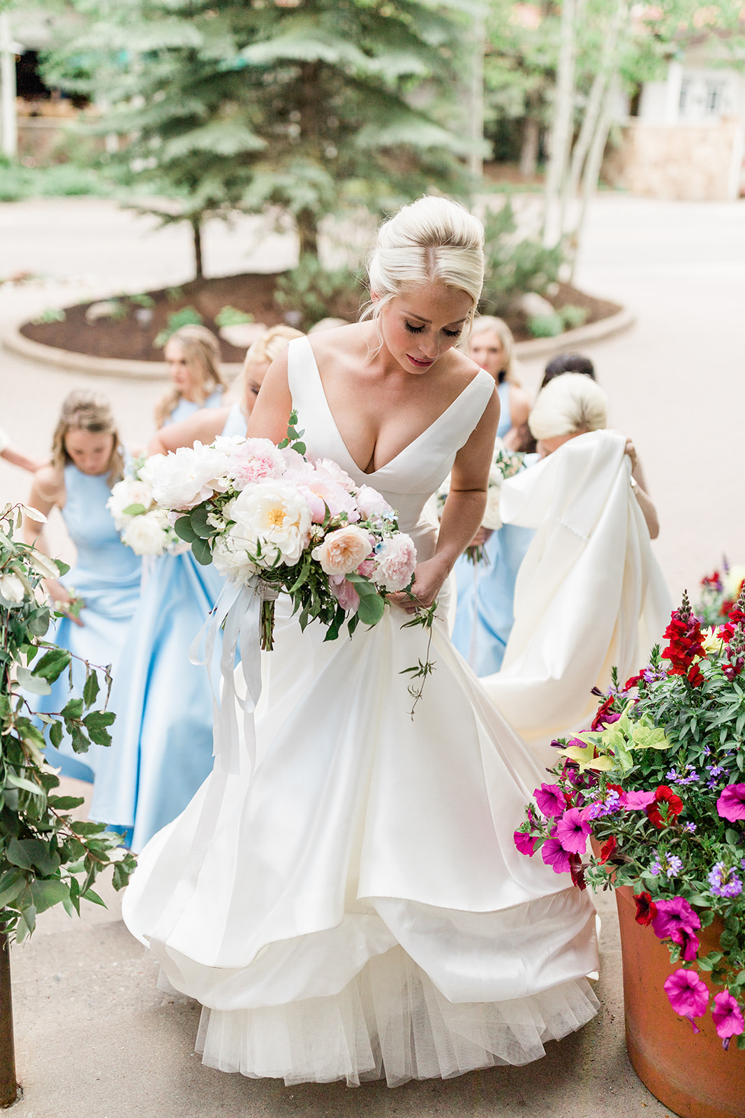 bride climbs the stairs to the Vail chapel for Colorado mountain wedding
